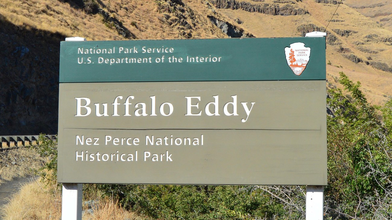 A green sign with the words 'Buffalo Eddy Nez Perce National Historical Park.'